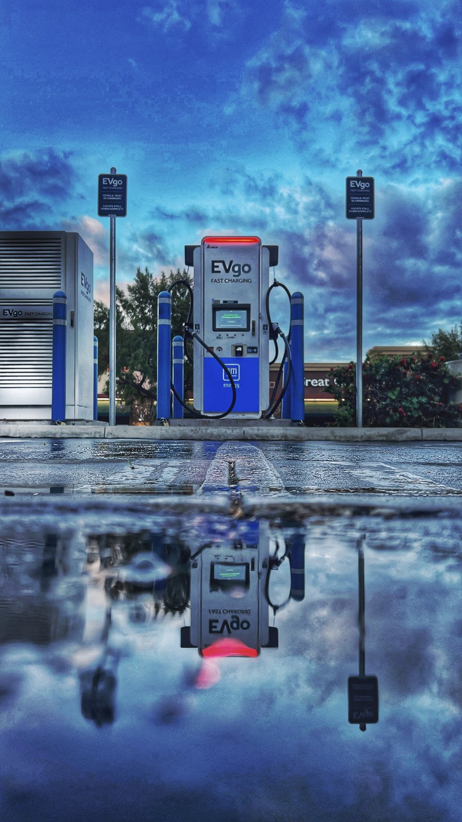 EVgo station, mirrored in a puddle