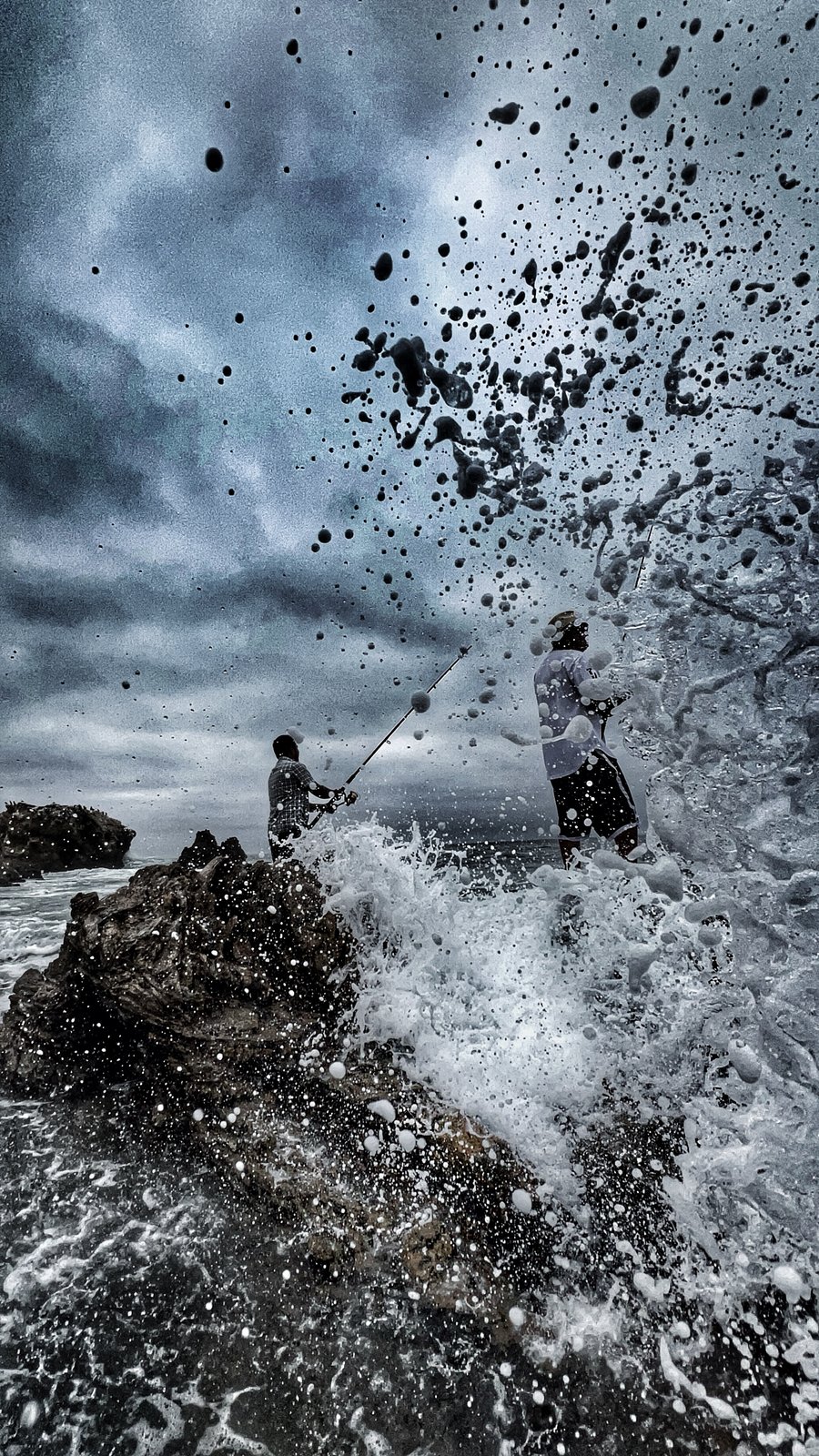 Anglers and the breaking sea